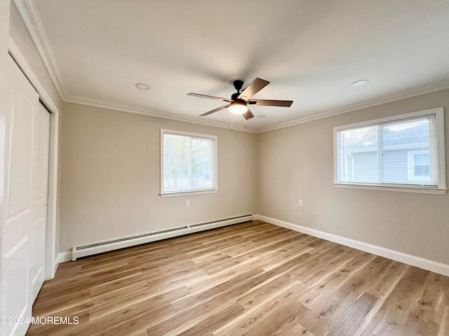 unfurnished bedroom with ceiling fan, hardwood / wood-style floors, ornamental molding, and a baseboard heating unit