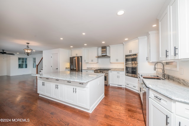 kitchen featuring white cabinets, sink, wall chimney exhaust hood, dark hardwood / wood-style floors, and stainless steel appliances