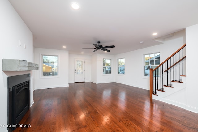 unfurnished living room featuring dark hardwood / wood-style floors, plenty of natural light, and ceiling fan