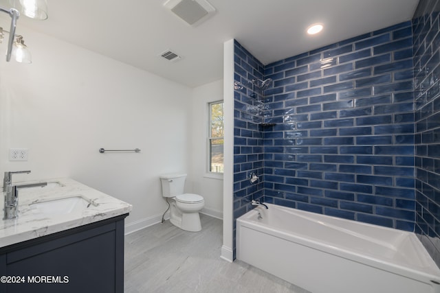 full bathroom with tiled shower / bath combo, toilet, and vanity