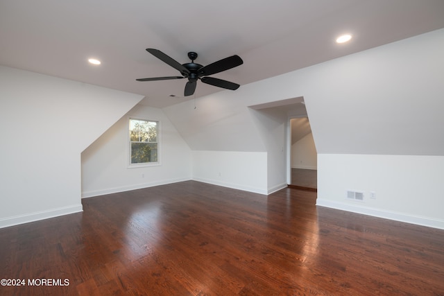 additional living space featuring ceiling fan, lofted ceiling, and dark wood-type flooring