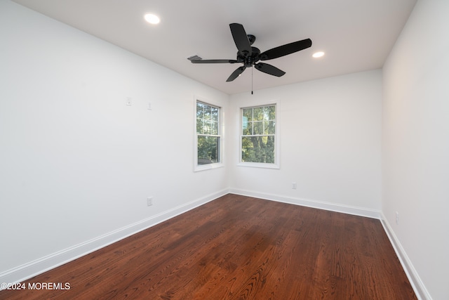 unfurnished room featuring ceiling fan and dark wood-type flooring