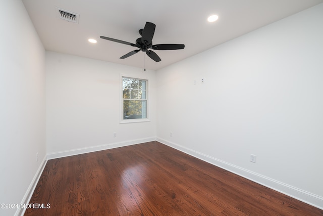 unfurnished room featuring ceiling fan and dark wood-type flooring