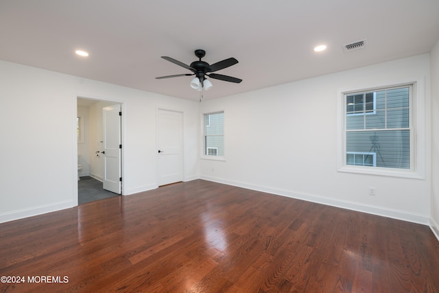 spare room featuring ceiling fan and dark hardwood / wood-style floors