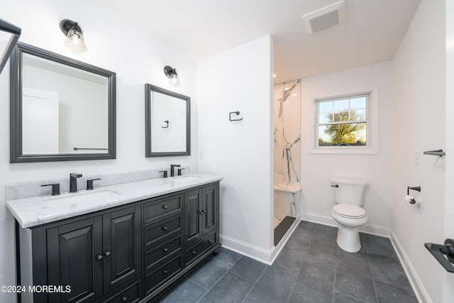 bathroom with tile patterned flooring, vanity, and toilet