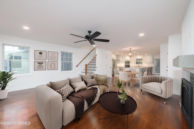 living room featuring dark hardwood / wood-style flooring and ceiling fan