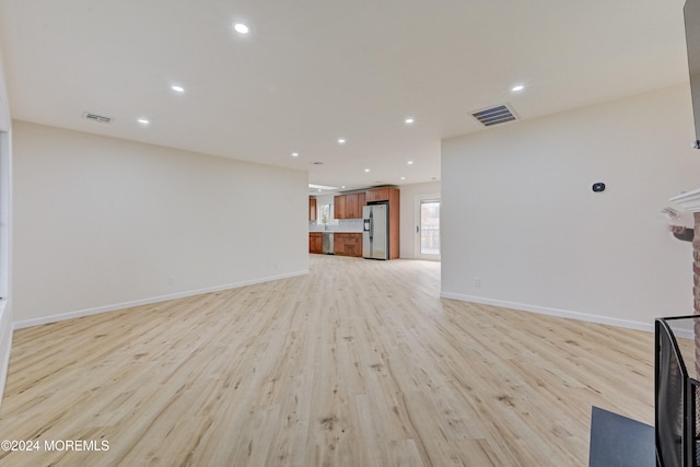 unfurnished living room with light wood-type flooring