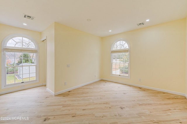 spare room featuring light hardwood / wood-style floors