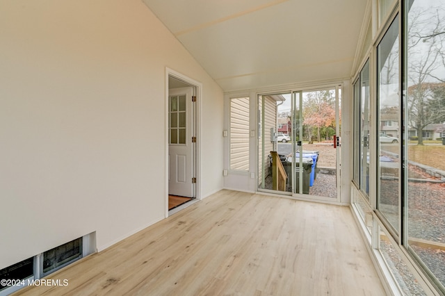 unfurnished sunroom featuring lofted ceiling