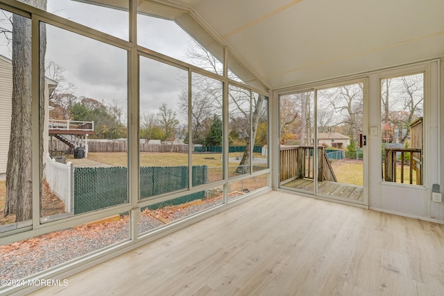 unfurnished sunroom with vaulted ceiling