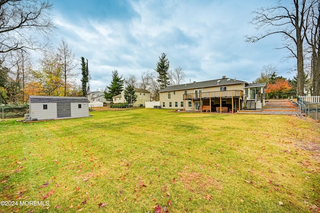 view of yard featuring an outbuilding and a wooden deck