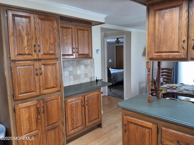 32 Village Rd, Morganville, NJ 07751 - kitchen with brown cabinetry, decorative backsplash, and ceiling fan