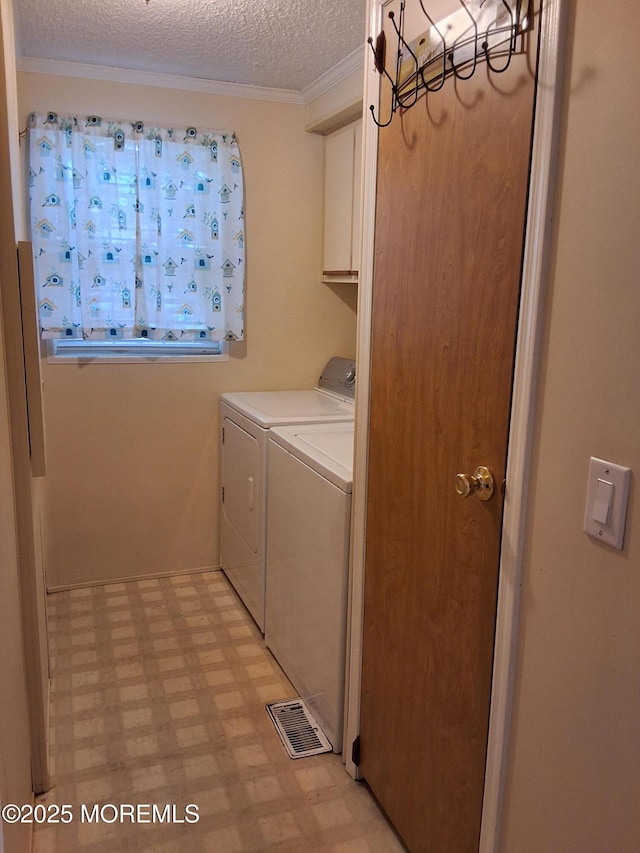32 Village Rd, Morganville, NJ 07751 - clothes washing area featuring light floors, visible vents, separate washer and dryer, cabinet space, and a textured ceiling