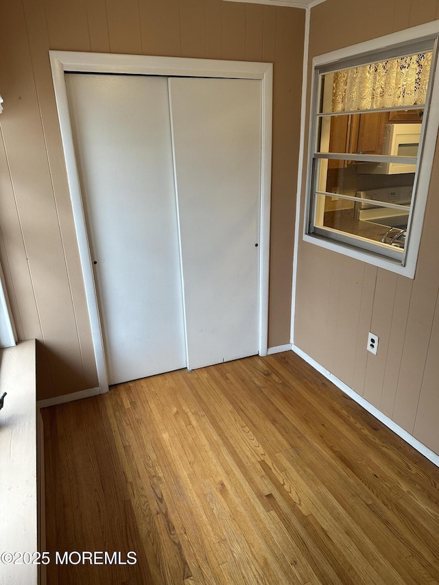 unfurnished bedroom featuring hardwood / wood-style floors and a closet