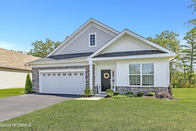 view of front facade with an attached garage, a shingled roof, stone siding, concrete driveway, and a front yard