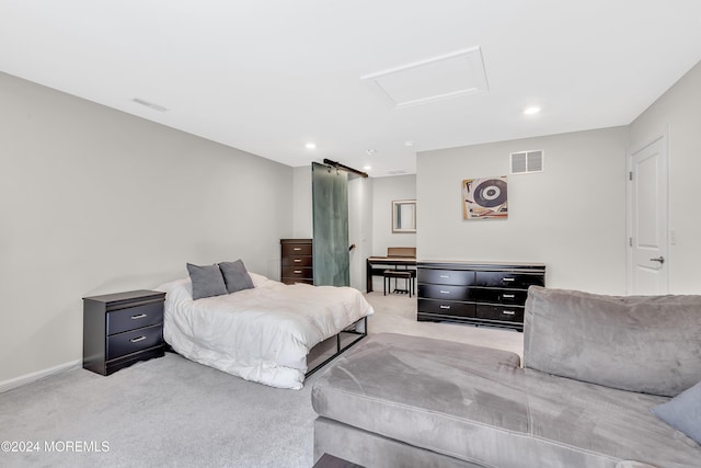 bedroom with attic access, light colored carpet, and visible vents