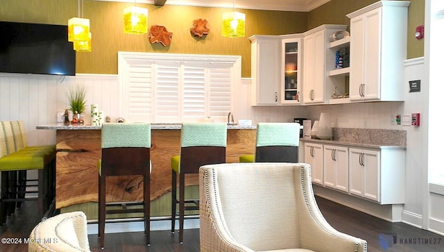 kitchen featuring dark wood-style floors, pendant lighting, open shelves, glass insert cabinets, and white cabinets