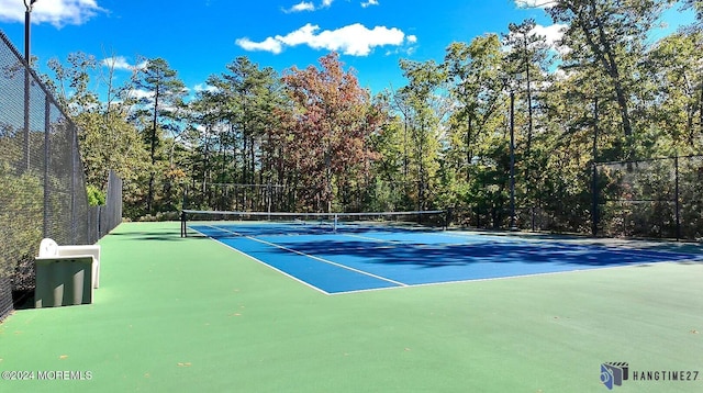 view of tennis court featuring fence