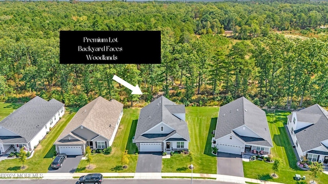 bird's eye view with a forest view and a residential view