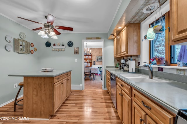 kitchen with a kitchen breakfast bar, ornamental molding, sink, and light hardwood / wood-style flooring