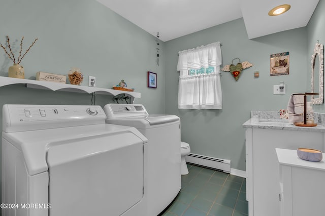 laundry room featuring separate washer and dryer and a baseboard heating unit