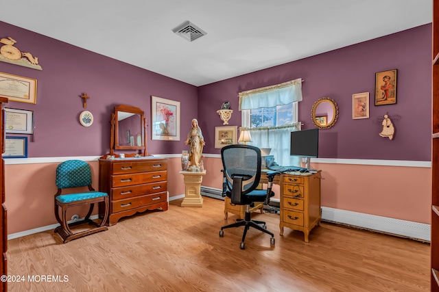 office area with light wood-type flooring and a baseboard radiator