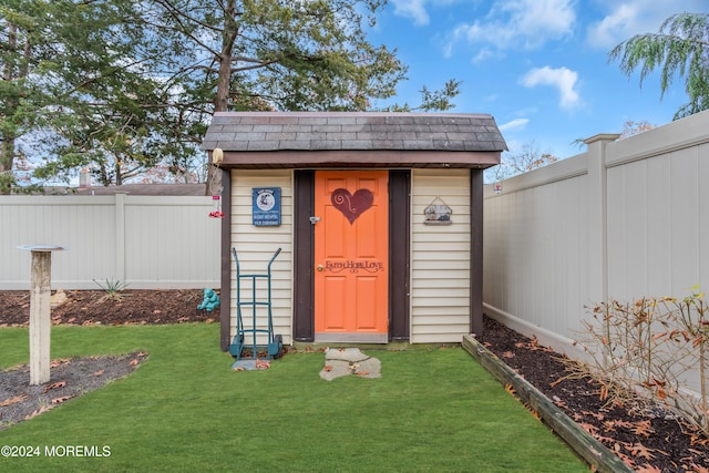 view of outbuilding with a lawn