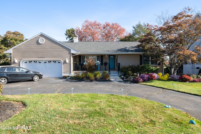 single story home featuring a front lawn, a porch, and a garage