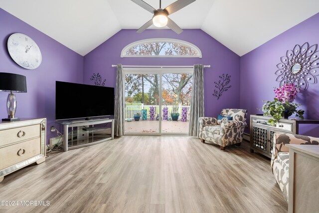 interior space with ceiling fan, light hardwood / wood-style floors, and vaulted ceiling