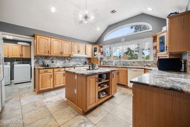 kitchen featuring dishwasher, hanging light fixtures, independent washer and dryer, a notable chandelier, and a kitchen island