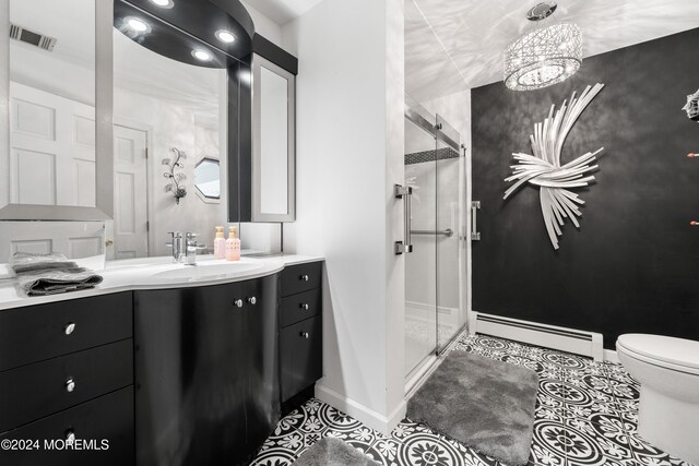 bathroom with vanity, a baseboard heating unit, tile patterned flooring, toilet, and an enclosed shower