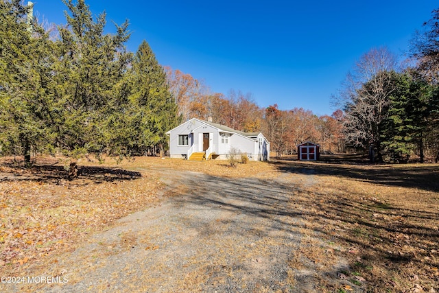 view of side of property featuring a storage shed