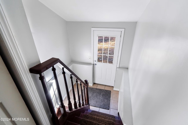 stairs featuring tile patterned flooring