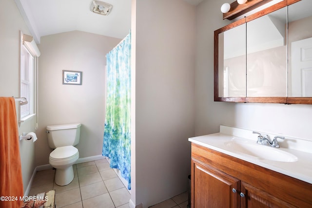 bathroom featuring tile patterned flooring, vanity, lofted ceiling, and toilet