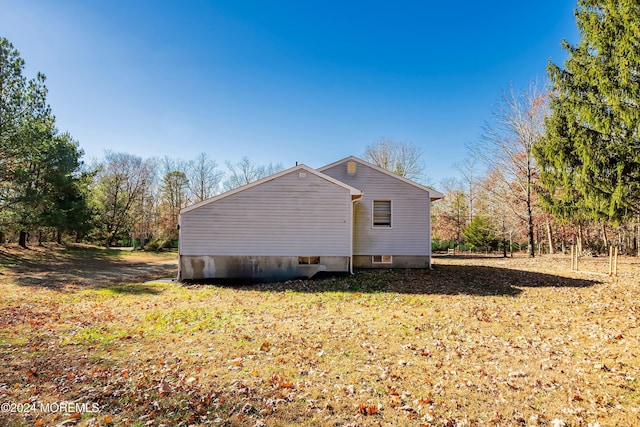 view of side of property with a yard