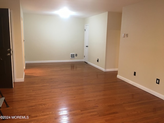 spare room with dark wood-type flooring