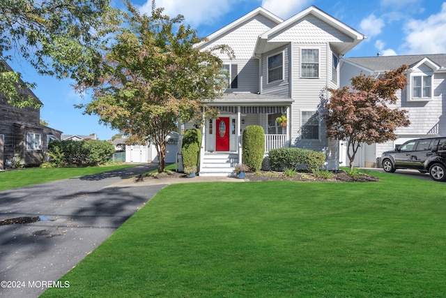 view of front of home with a porch and a front lawn