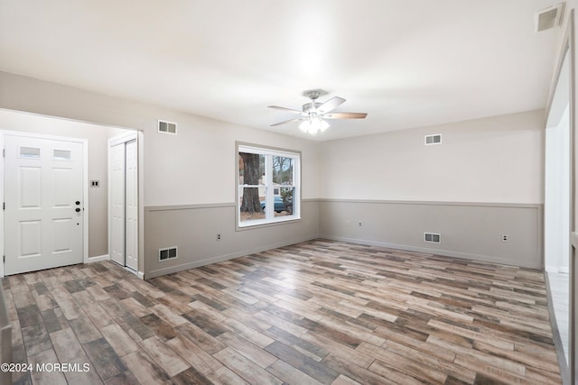 unfurnished room with ceiling fan and wood-type flooring