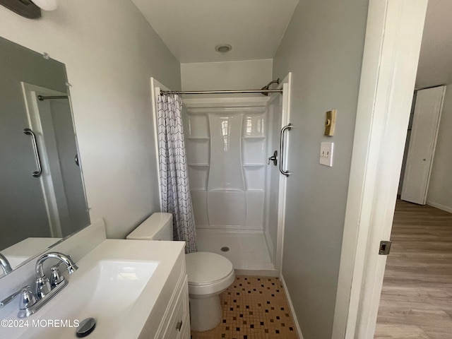 bathroom featuring a shower with curtain, toilet, vanity, and hardwood / wood-style flooring