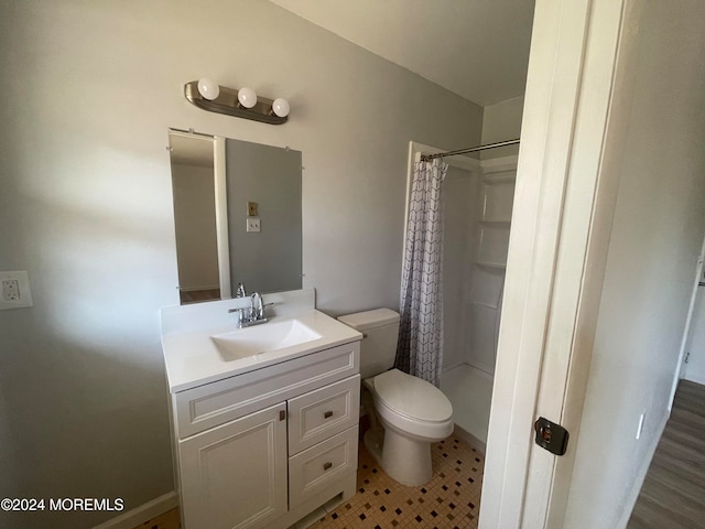 bathroom featuring tile patterned floors, vanity, toilet, and walk in shower