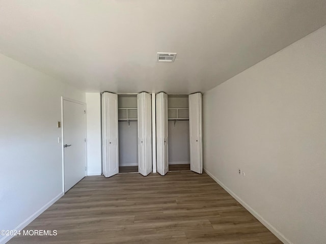 unfurnished bedroom with dark hardwood / wood-style floors