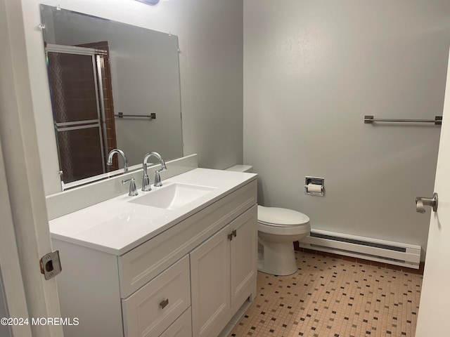 bathroom featuring baseboard heating, vanity, an enclosed shower, and toilet