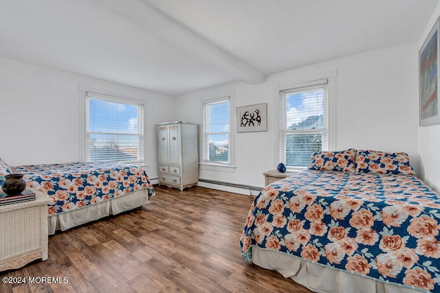 bedroom with a baseboard heating unit, beam ceiling, and dark hardwood / wood-style floors