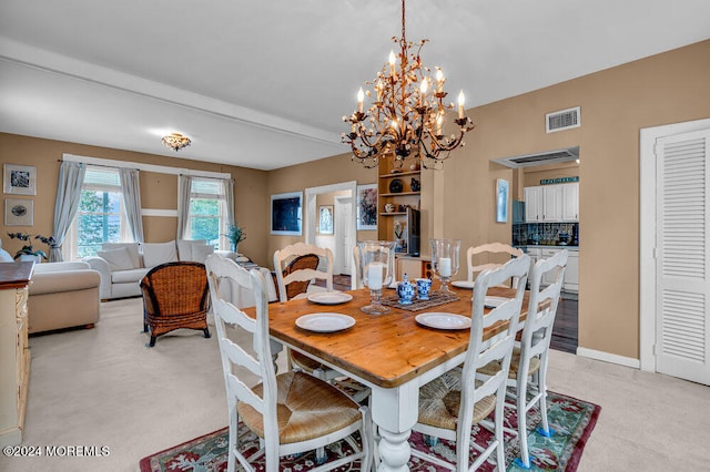 dining area featuring light colored carpet, beam ceiling, and a notable chandelier