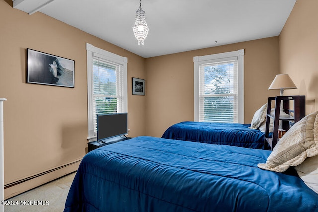 bedroom with a baseboard radiator, multiple windows, and light carpet