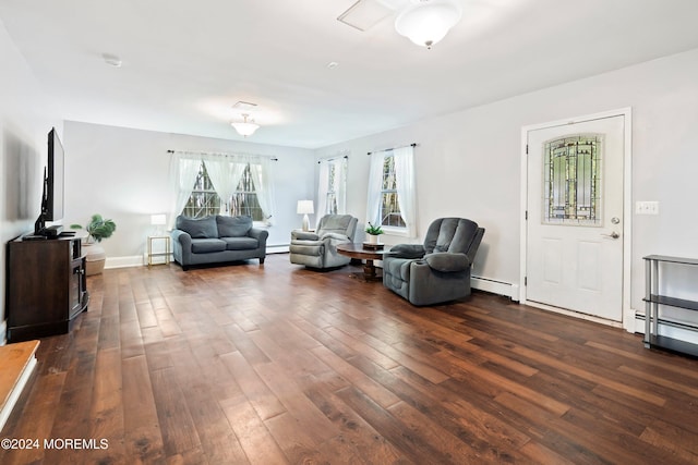 living room with baseboard heating and dark hardwood / wood-style floors