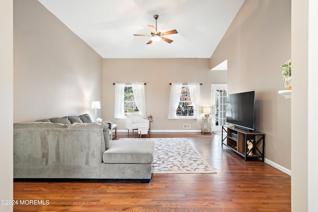 living room with vaulted ceiling, ceiling fan, and dark hardwood / wood-style floors