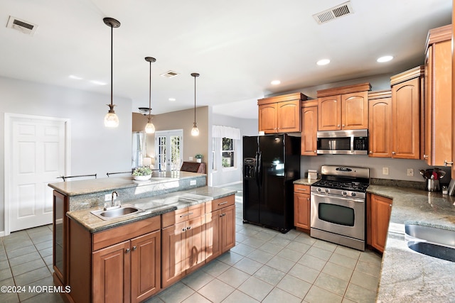 kitchen with sink, hanging light fixtures, light tile patterned floors, a kitchen island, and stainless steel appliances