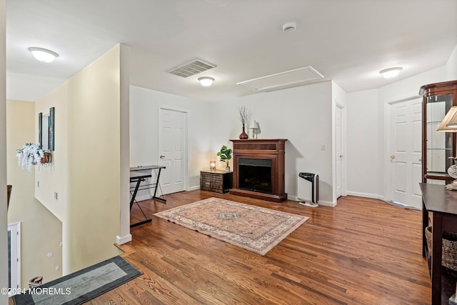 living room featuring heating unit and hardwood / wood-style flooring