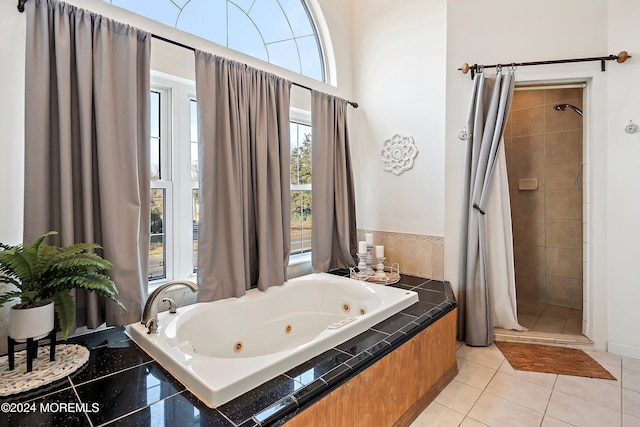 bathroom featuring plus walk in shower and tile patterned floors